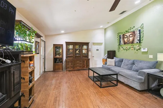 an aerial view of a house with yard and mountain view in back