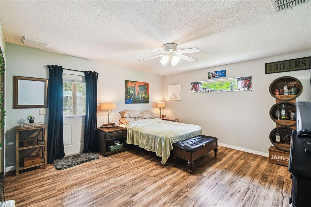 12604 Choctaw Trail Hudson, FL 34669 - Photo 37 of 92 a bedroom with a bed and wooden floor