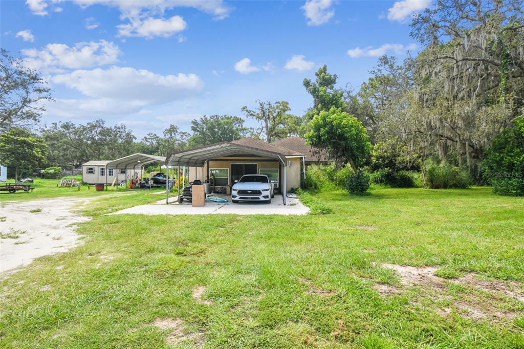 12604 Choctaw Trail Hudson, FL 34669 - Photo 63 of 92 a front view of a house with garden and sitting area