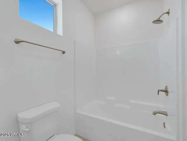 a bathroom with a bathtub and a toilet