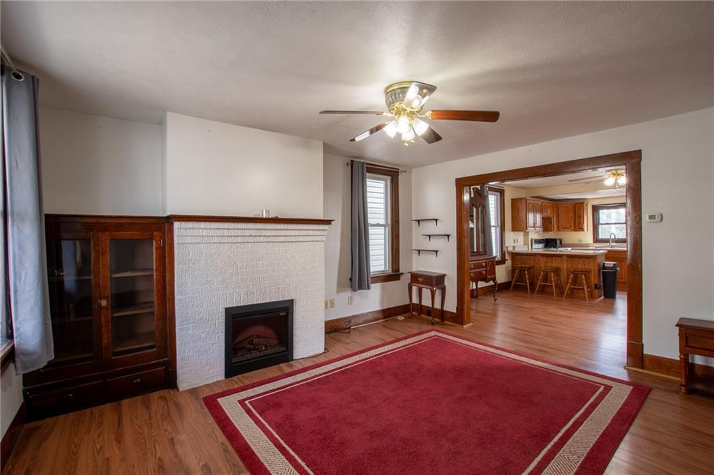 431 East Washington Street Rochester, PA 15074 - Photo 11 of 32 a living room with furniture a fireplace and wooden floor