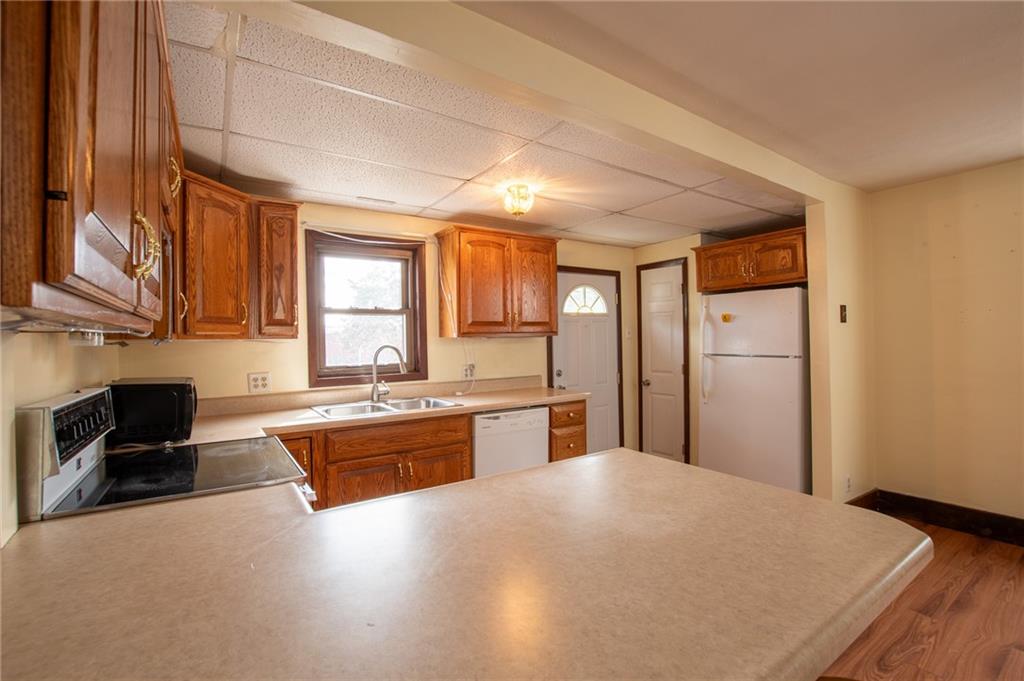 431 East Washington Street Rochester, PA 15074 - Photo 18 of 32 a large kitchen with kitchen island granite countertop a large window a oven a sink and stainless steel appliances