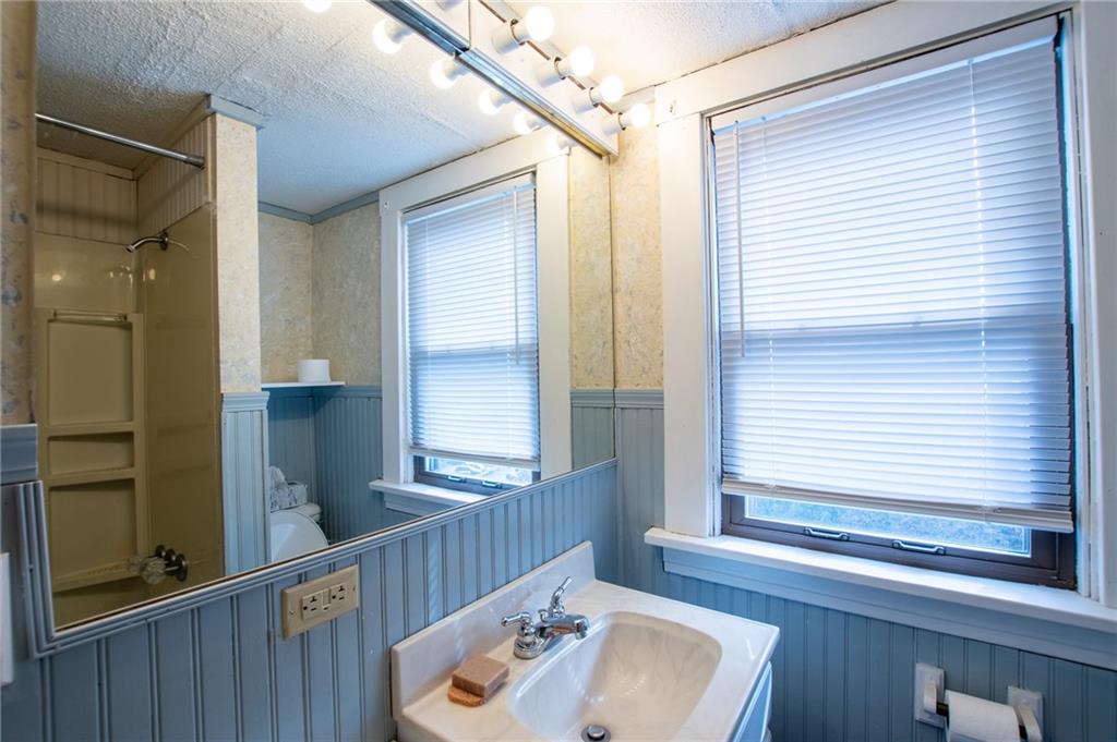 431 East Washington Street Rochester, PA 15074 - Photo 20 of 32 a bathroom with a sink a mirror and next to a window