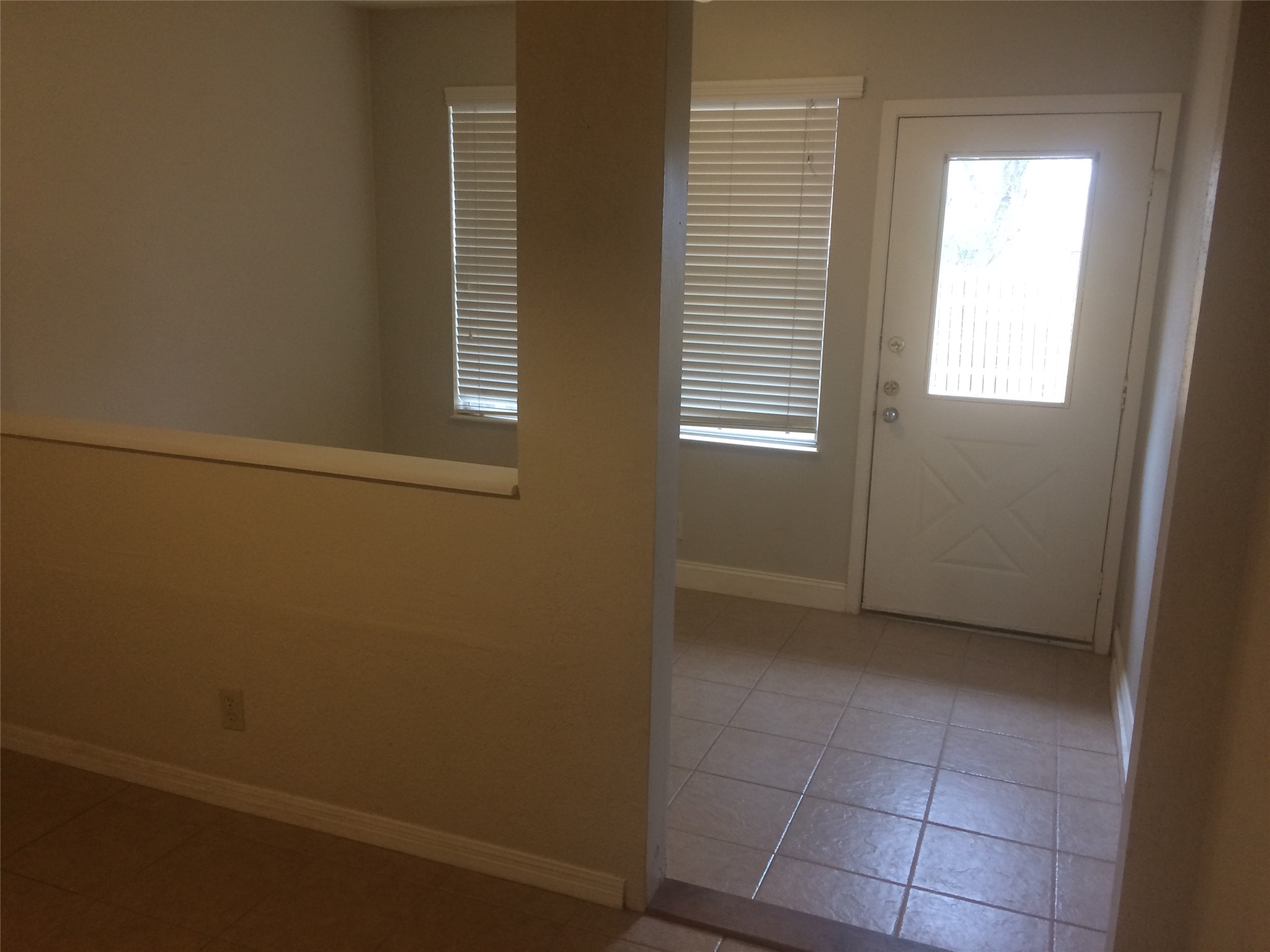 102 Verna Spur, Unit B Georgetown, TX 78628 - Photo 11 of 18 Back door with baseboards and tile patterned flooring