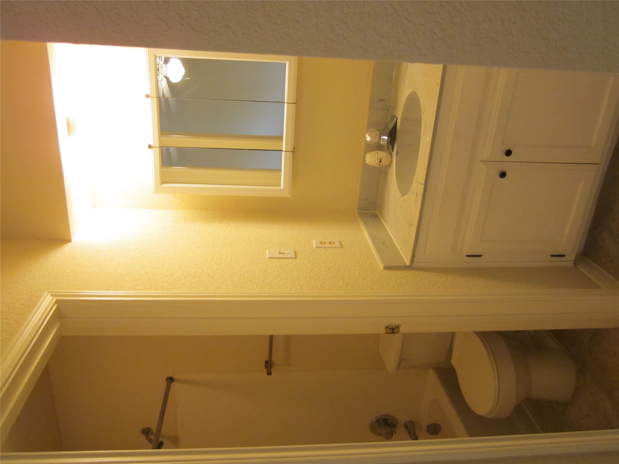 102 Verna Spur, Unit B Georgetown, TX 78628 - Photo 16 of 18 Full bath featuring a textured wall, vanity, washtub / shower combination, and dark tile patterned flooring