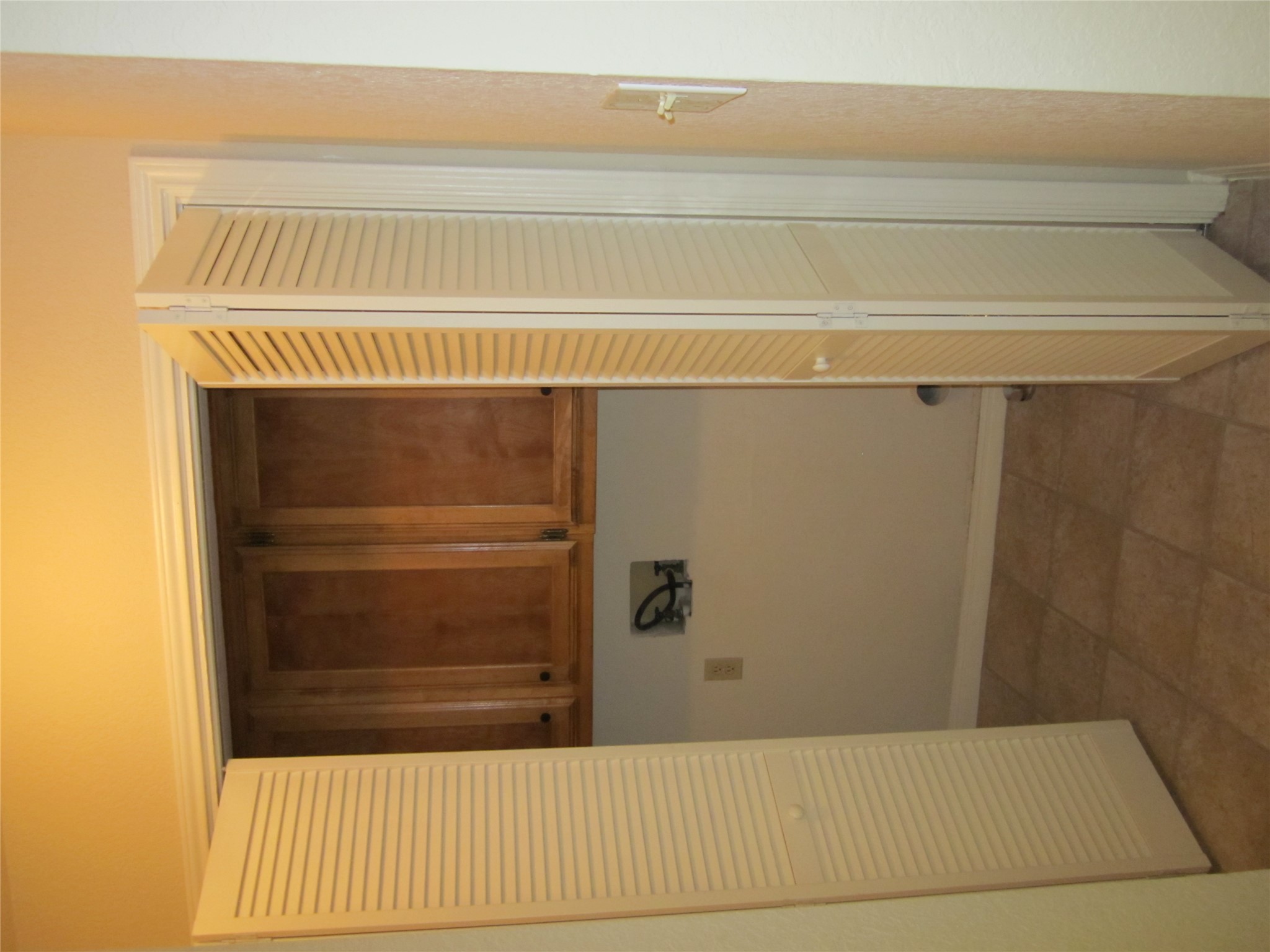 102 Verna Spur, Unit B Georgetown, TX 78628 - Photo 17 of 18 Laundry room with cabinet space, hookup for a washing machine, and light tile patterned floors