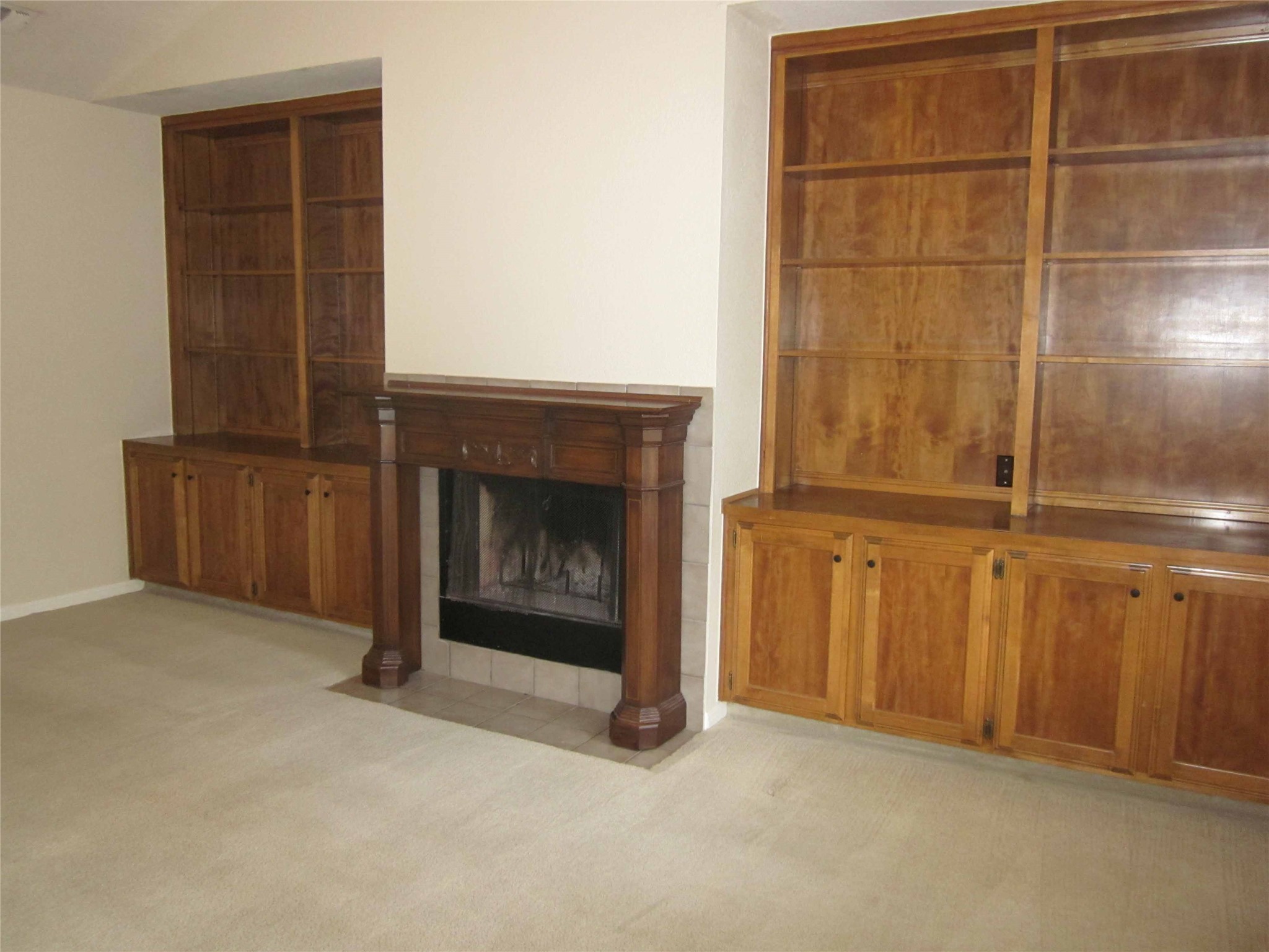 102 Verna Spur, Unit B Georgetown, TX 78628 - Photo 8 of 18 Unfurnished living room with light carpet and a tile fireplace
