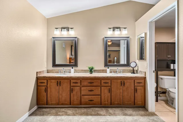 a bathroom with a double vanity sink and mirror
