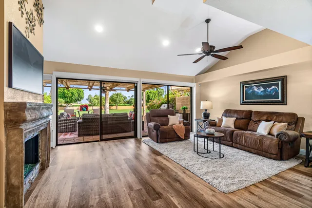 a living room with granite countertop furniture a fireplace and a flat screen tv