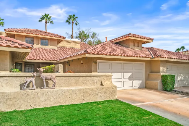 a blue sign that is sitting on a brick wall