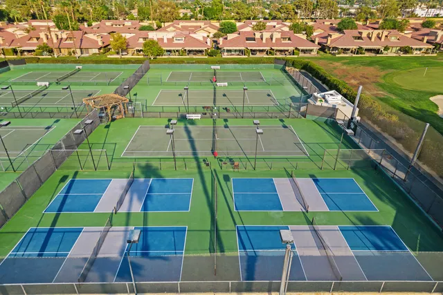 a view of a house with swimming pool and sitting area