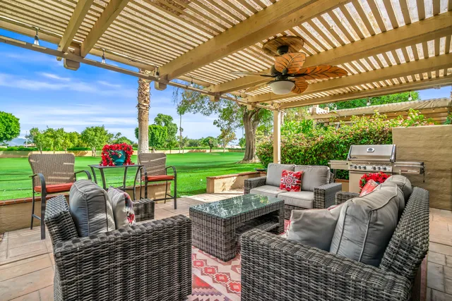 a view of a house with backyard porch and sitting area