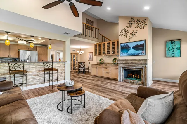 a view of a patio with couches and table and chairs and potted plants