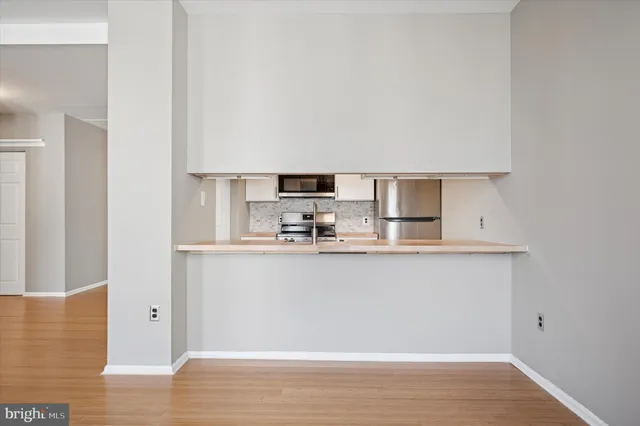 a view of kitchen with stainless steel appliances granite countertop refrigerator sink and stove