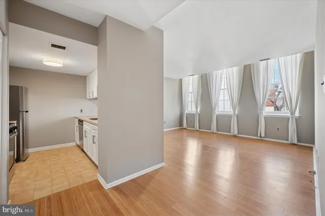 a view of empty room with wooden floor