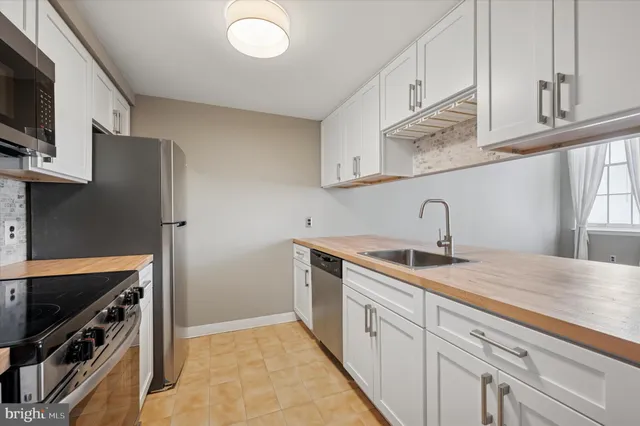 a kitchen with stainless steel appliances granite countertop a sink and a stove