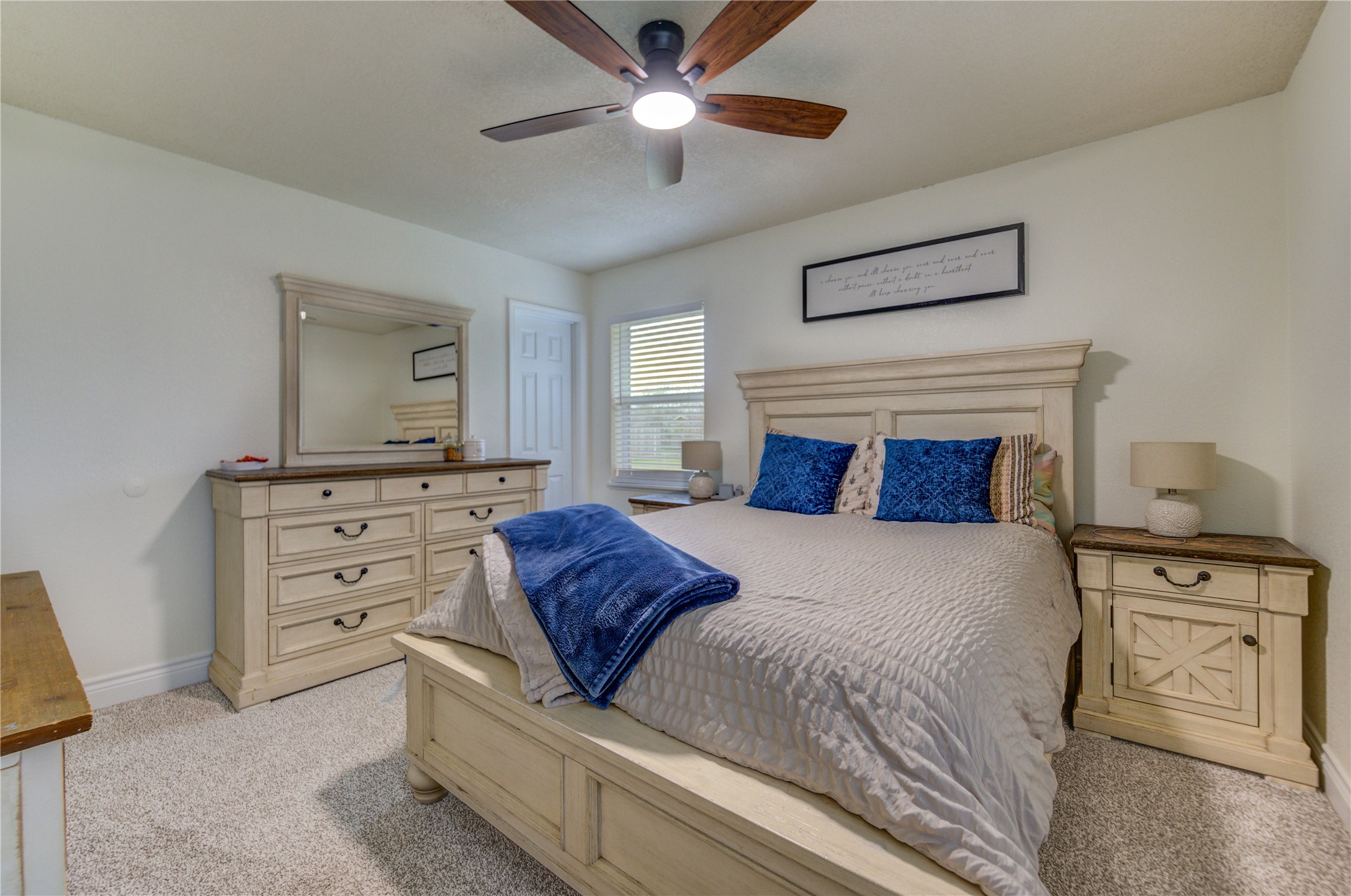 7706 Colston Place Santa Fe, TX 77510 - Photo 11 of 16 a bedroom with a bed and a chandelier