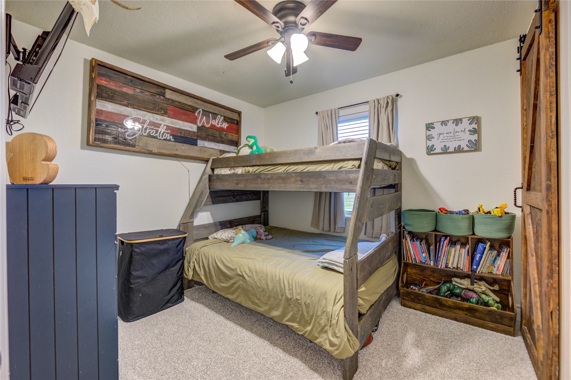 7706 Colston Place Santa Fe, TX 77510 - Photo 13 of 16 a bedroom with a bed and a chandelier