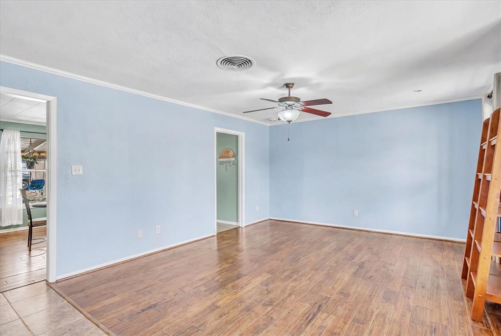 709 Hurstview Drive Hurst, TX 76053 - Photo 17 of 28 an empty room with wooden floor and chandelier fan