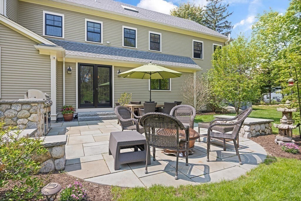 36 Tyler Road Lexington, MA 02420 - Photo 33 of 38 a view of a patio with table and chairs under an umbrella