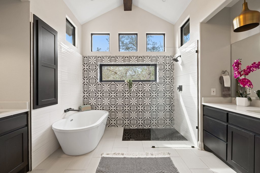 4018 Bee Creek Road Spicewood, TX 78669 - Photo 31 of 40 Spa like primary bath with soaking tub, walk in shower, and dual vanities.