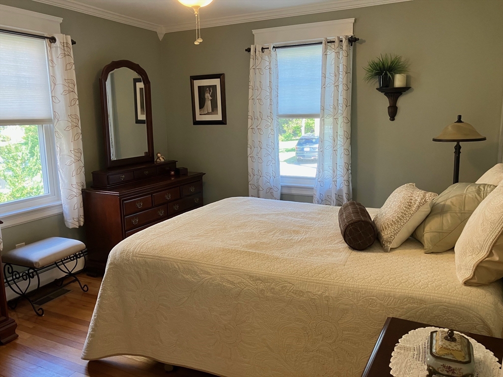 93 Crown Avenue Riverside, RI 02915 - Photo 12 of 33 a bedroom with a bed and wooden floor