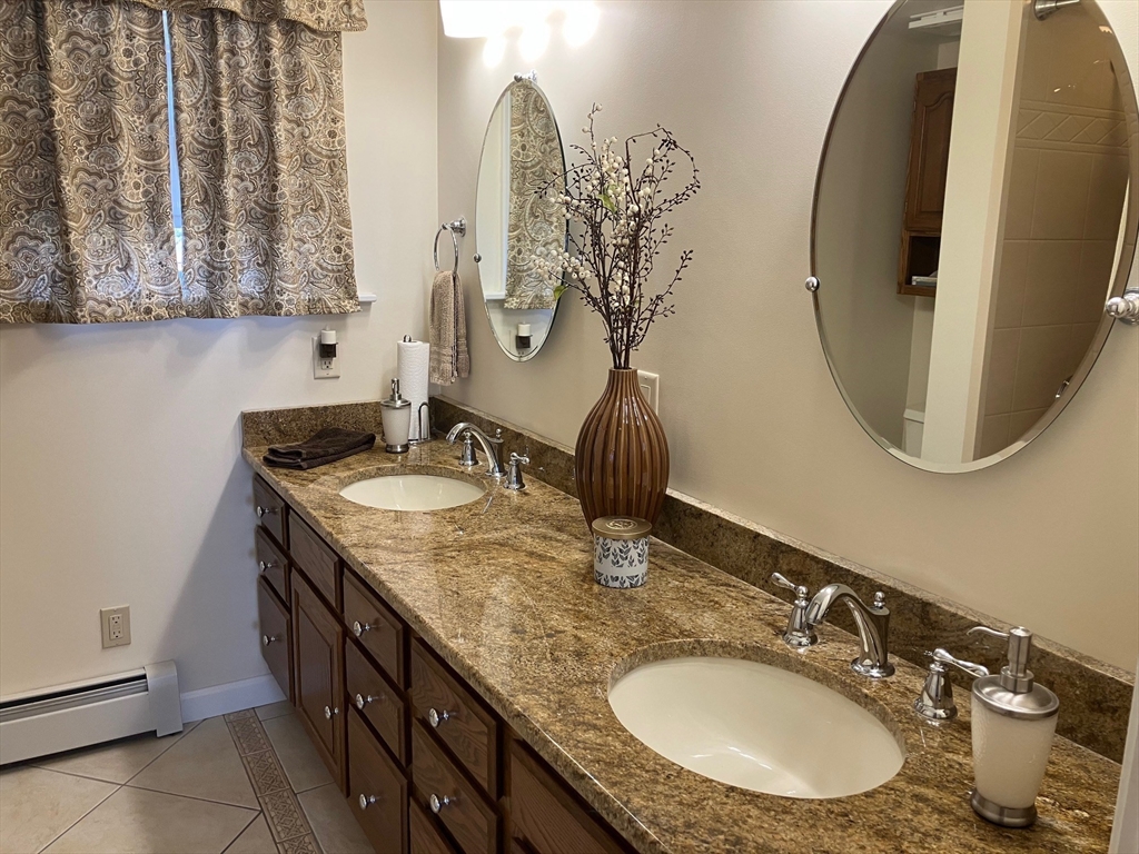 93 Crown Avenue Riverside, RI 02915 - Photo 14 of 33 a bathroom with a granite countertop sink and a mirror