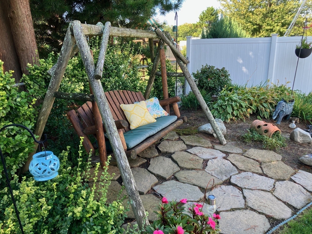 93 Crown Avenue Riverside, RI 02915 - Photo 30 of 33 a backyard of a house with lots of green space and plants