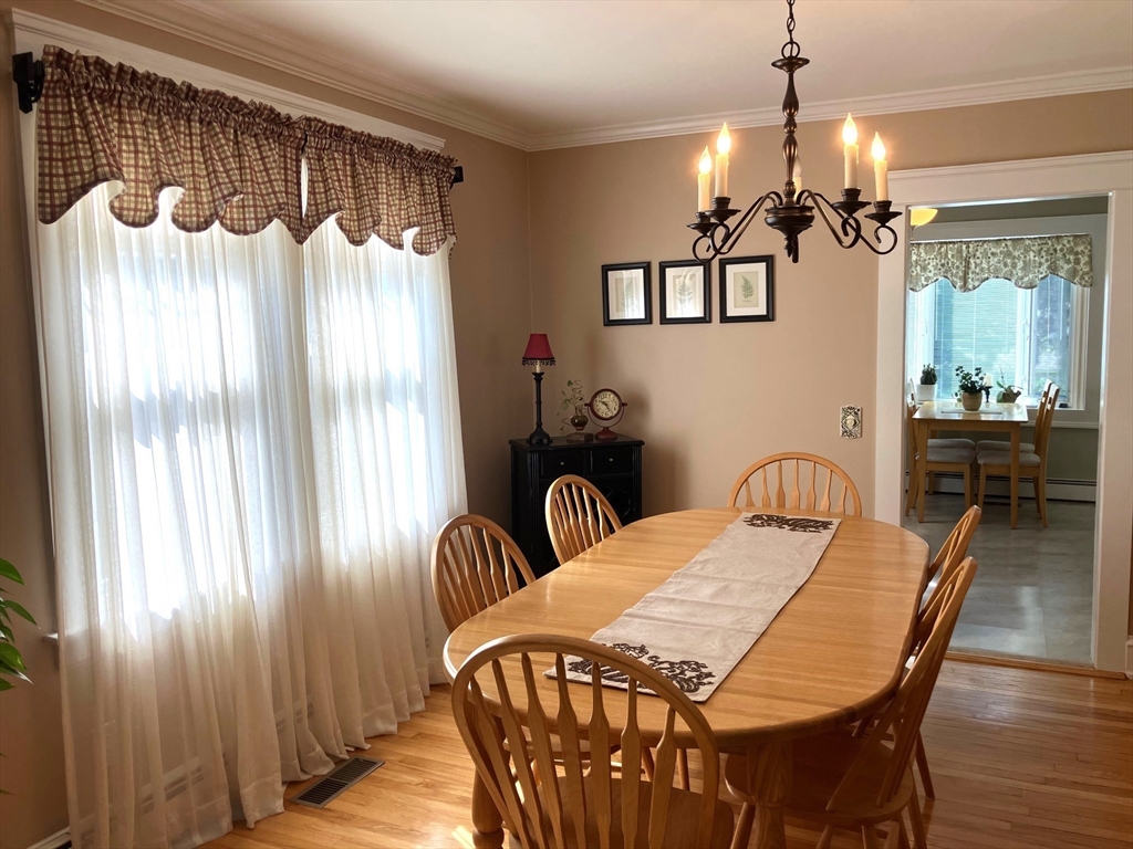 93 Crown Avenue Riverside, RI 02915 - Photo 8 of 33 a view of a dining room with furniture window and wooden floor