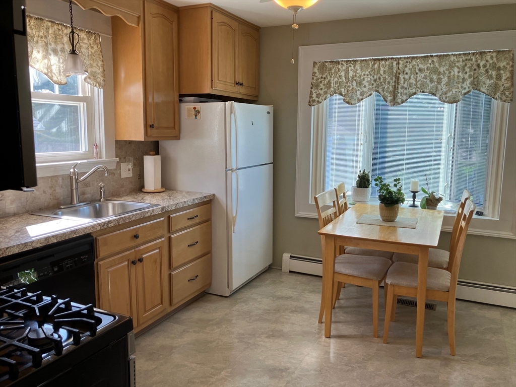 93 Crown Avenue Riverside, RI 02915 - Photo 10 of 33 a kitchen with a sink stove and refrigerator