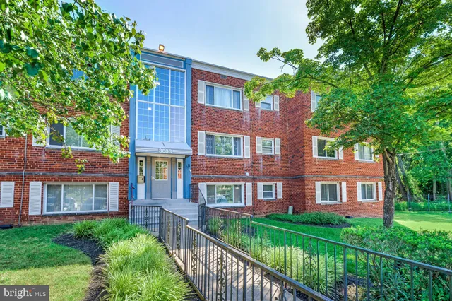 a view of a brick building next to a yard