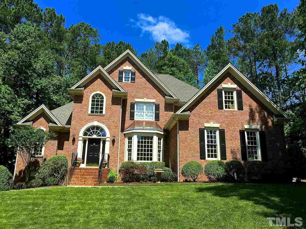 5805 Sand Pebble Place Raleigh, NC 27613 - Photo 1 of 17 a front view of a house with a yard and garage