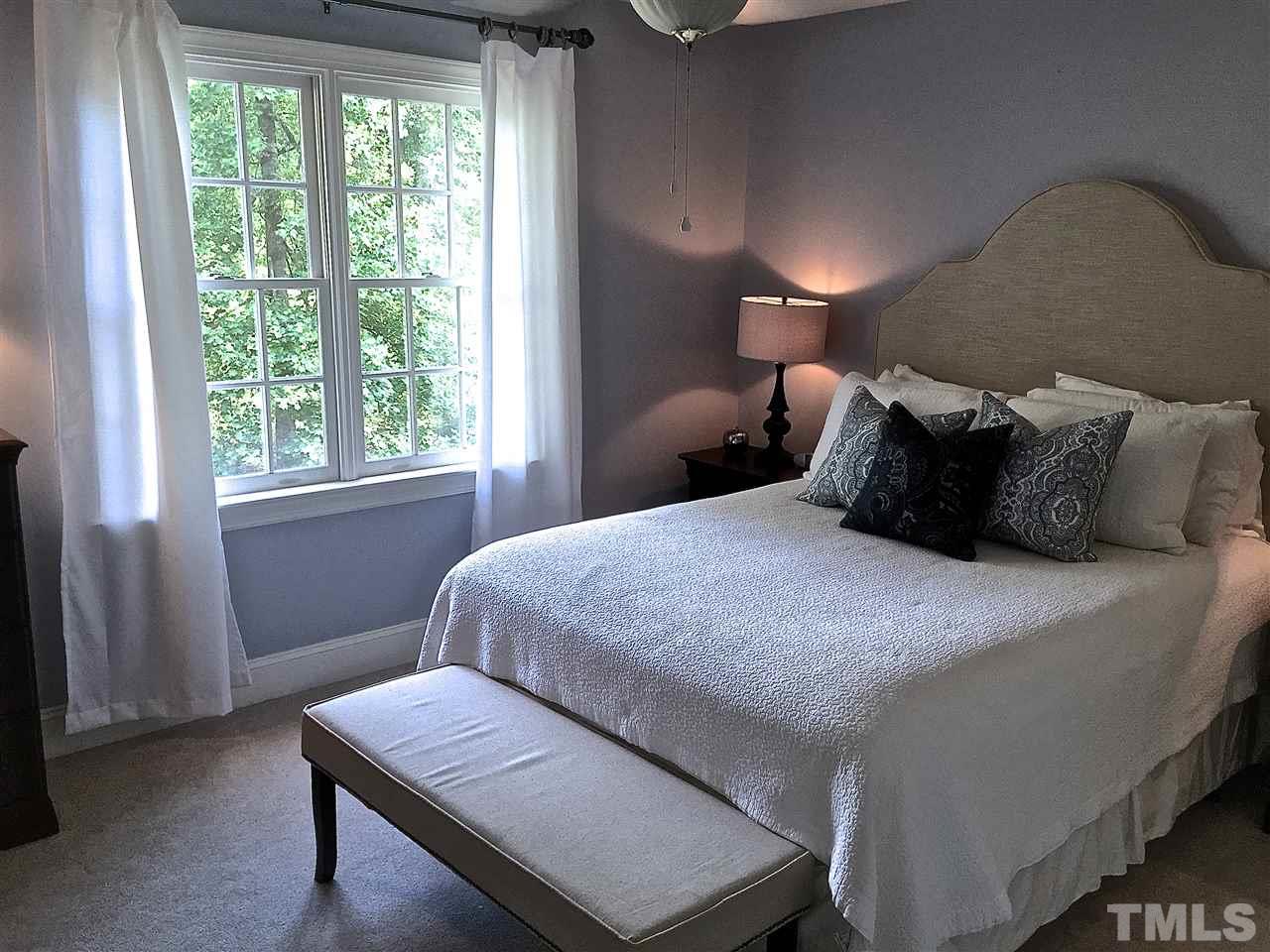 5805 Sand Pebble Place Raleigh, NC 27613 - Photo 10 of 17 a bedroom with a bed and window