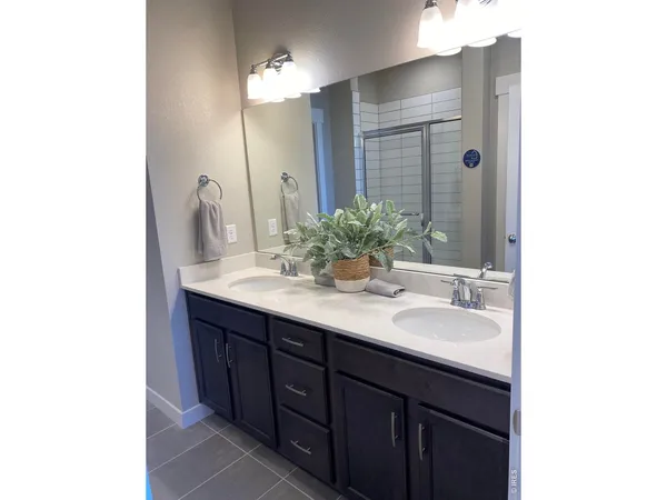 a bathroom with a double vanity sink and a mirror