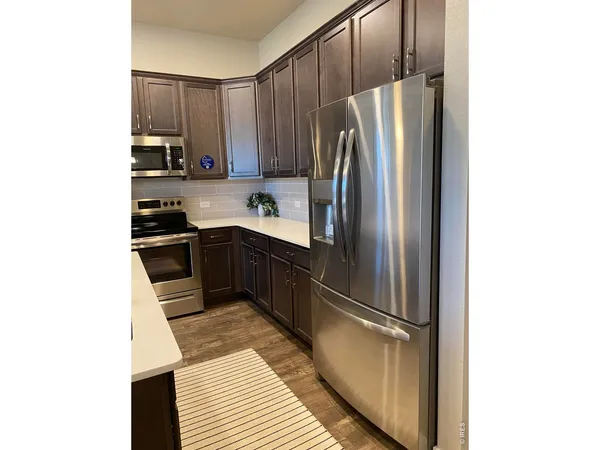 a kitchen with stainless steel appliances a refrigerator and a sink