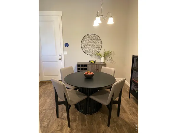 a view of a dining room with a table and chairs