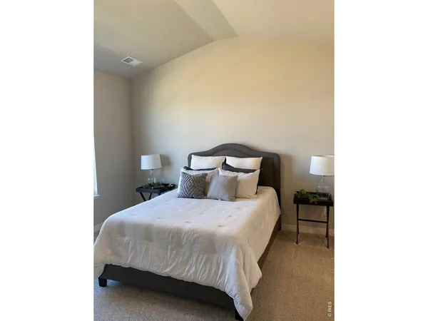 a bedroom with a bed and a lamp