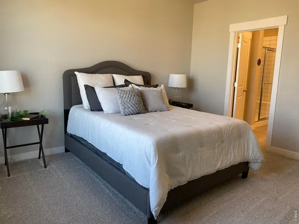 a bedroom with a bed and a lamp