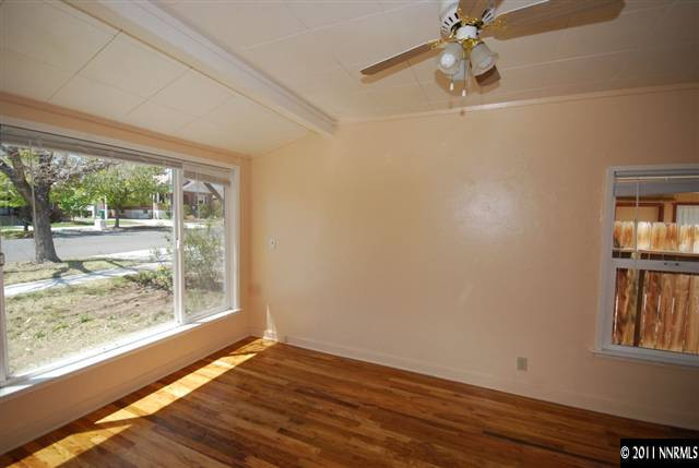 1024 Bell Street Reno, NV 89503 - Photo 4 of 13 an empty room with wooden floor and windows