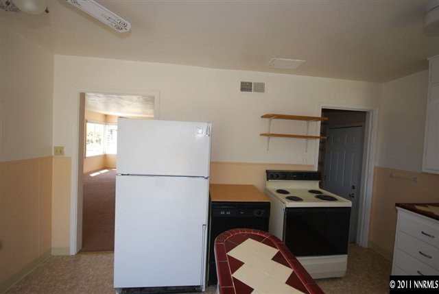 1024 Bell Street Reno, NV 89503 - Photo 8 of 13 a white refrigerator freezer and a stove sitting inside of a kitchen
