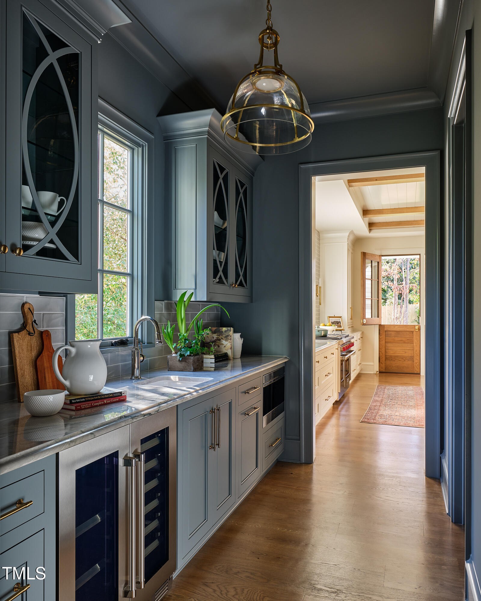 1307 Mayfair Road Raleigh, NC 27608 - Photo 29 of 59 a kitchen with a refrigerator and a wooden floor