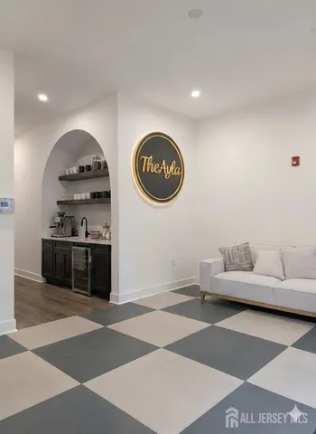 a living room with furniture and a kitchen area