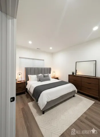 a bedroom with a bed and lamps