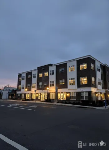 a living room with a large window and kitchen view