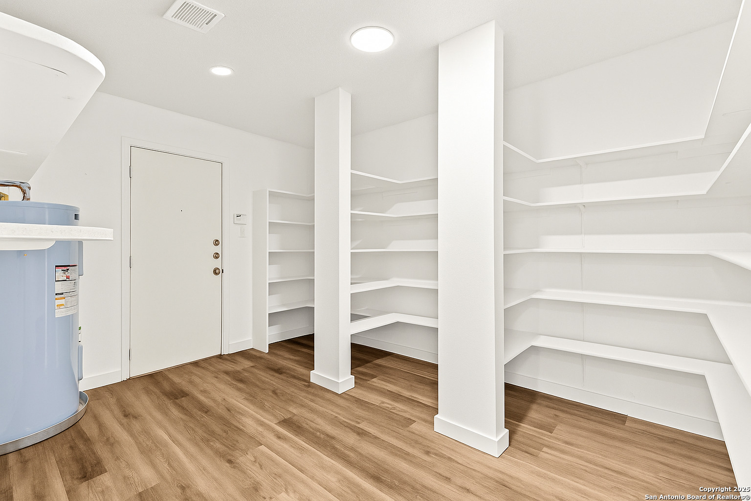 1687 Fir Circle Schertz, TX 78154 - Photo 12 of 25 a view of an empty room with wooden floor and entryway