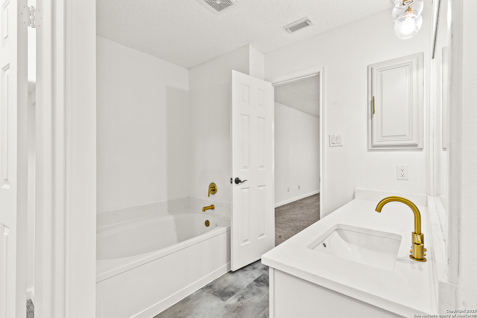 1687 Fir Circle Schertz, TX 78154 - Photo 15 of 25 a bathroom with a tub sink and mirror