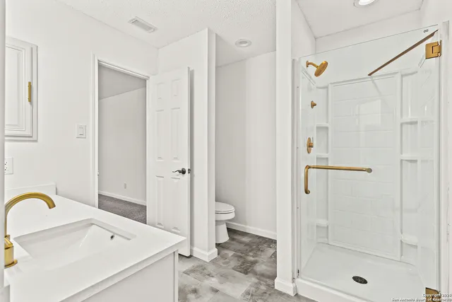 a bathroom with a sink toilet and shower