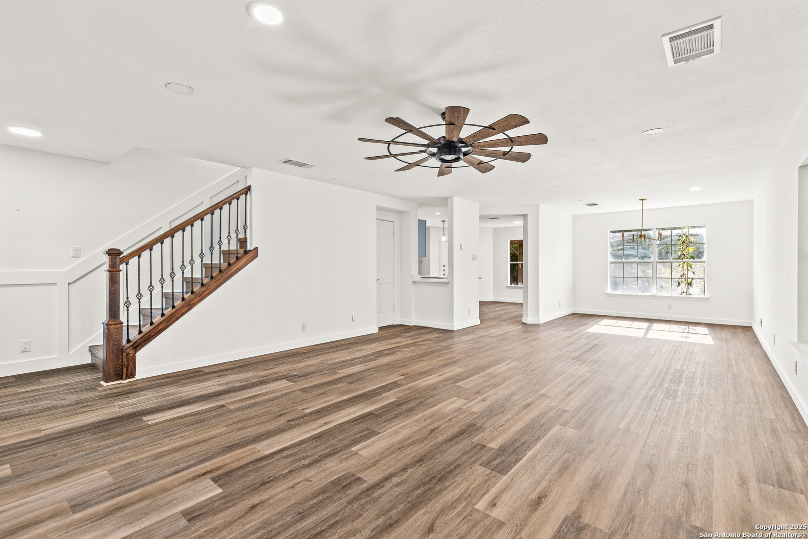 1687 Fir Circle Schertz, TX 78154 - Photo 4 of 25 a view of an empty room with wooden floor and a window