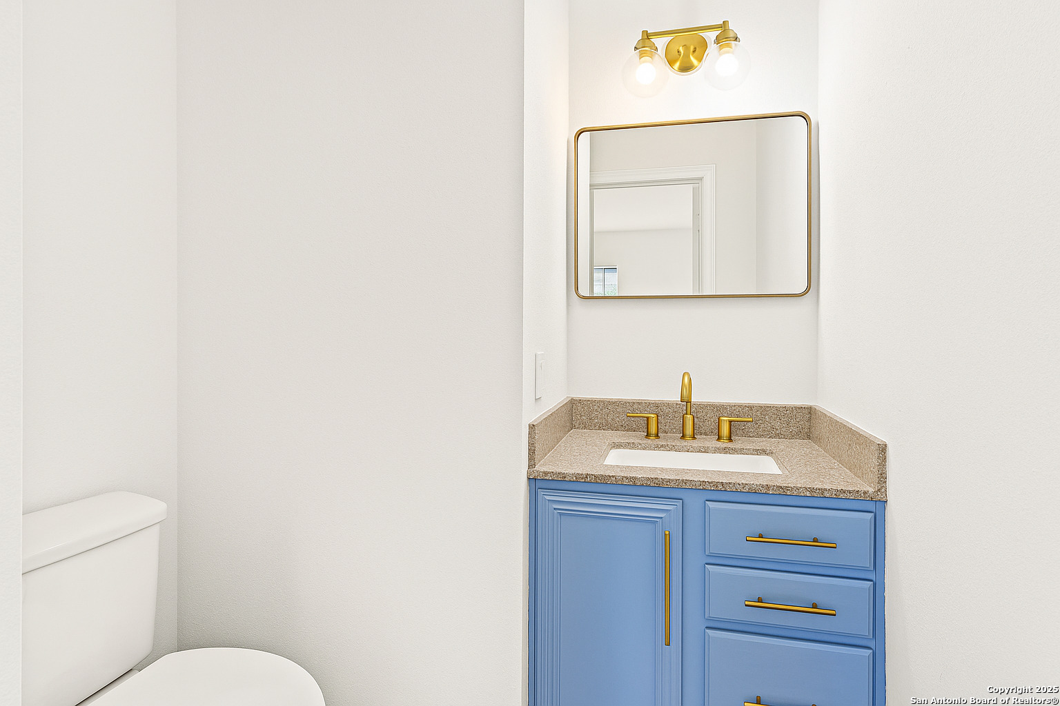 1687 Fir Circle Schertz, TX 78154 - Photo 5 of 25 a bathroom with a toilet sink vanity and mirror