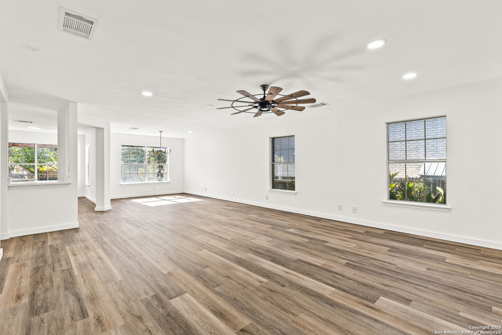 1687 Fir Circle Schertz, TX 78154 - Photo 6 of 25 a view of an empty room with a window and wooden floor